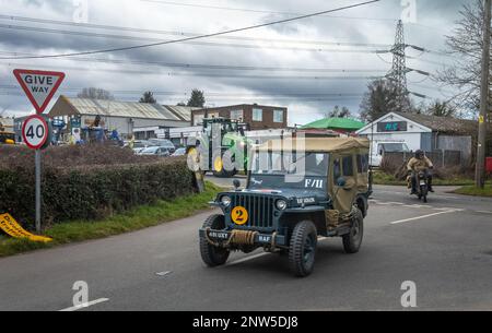 A WW2-era Jeep painted in RAF livery rounds a corner followed by a WW2-era Norton motorcycle at a vintage vehicles event in Wisborough Green, UK. Stock Photo
