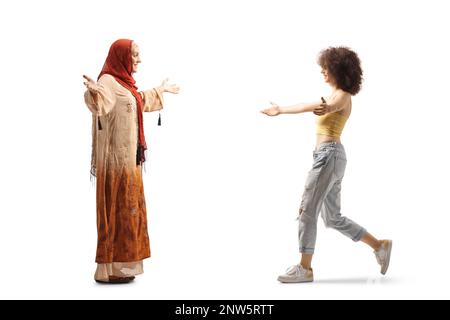 Young muslim woman meeting a caucasian young woman isolated on white background Stock Photo