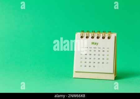 Desktop calendar for May 2023 on a green background Stock Photo