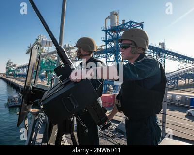 230101-N-UL352-1015 FUJAIRAH, United Arab Emirates (Jan. 1, 2023) Gunner’s Mate 3rd Class Joshua Lesnar, left, and Gunner’s Mate Seaman Jesse Deese, assigned to guided-missile destroyer USS Delbert D. Black (DDG 119), stand watch as the ship pulls into the port of Fujairah, United Arab Emirates, Jan. 1. Delbert D. Black is deployed to the U.S. 5th Fleet area of operations to help ensure maritime security and stability in the Middle East region. Stock Photo