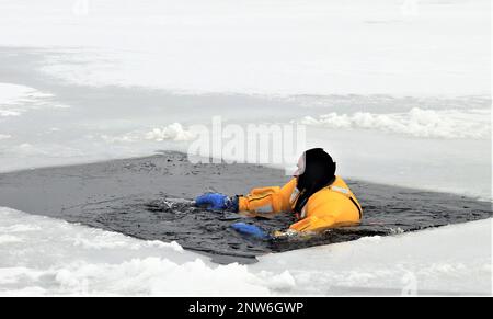 A firefighter wearing a cold-water immersion protective suit acts as a ...