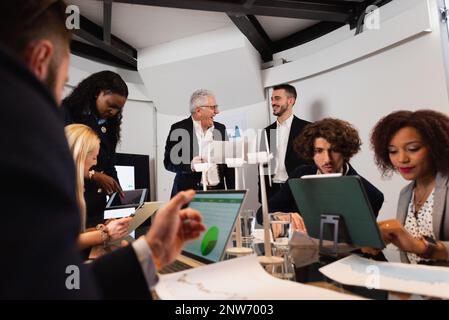 Large group of colleagues with diverse ethnicity working together on a renewable energy project. sustainability concept. Stock Photo