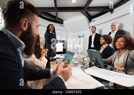 Diverse ethnicity teamwork discussing about new projects. People sitting at desk during a meeting corporation. Stock Photo
