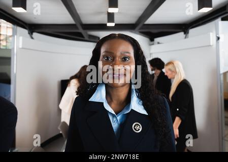 Portrait of african attractive mature businesswoman posing at camera . Unfocused multiracial teamwork working on background Stock Photo