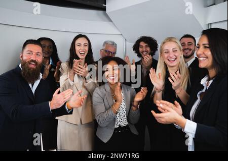 Multiracial group of businesspeople clapping hands with happy faces.congratulate for Business achievement and success concept. Stock Photo