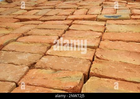 In the pile is a ready-made fired brick made of clay Stock Photo