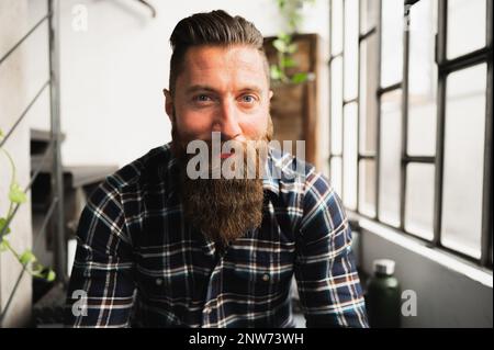 Close-up young hipster man looking at camera smiling. Stock Photo
