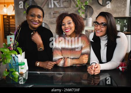 Group of three multiethnic women looking at camera. Stock Photo