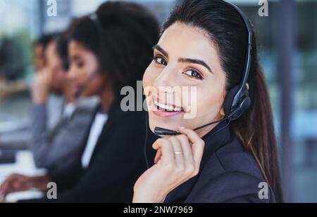 I might just have all the answers you need. Portrait of a young woman working in a call centre. Stock Photo