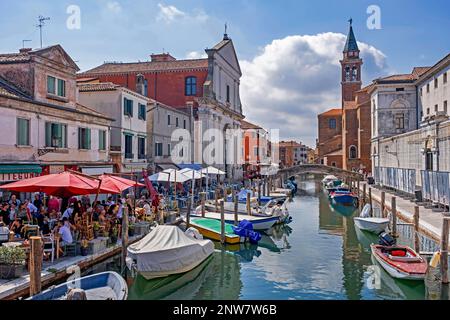 Restaurants along canal Vena at Chioggia, coastal town on small island at southern entrance to the Venetian Lagoon near Venice, Veneto, Northern Italy Stock Photo