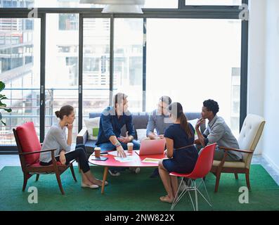 Ideas are flowing. Shot of a group of office workers talking together in a meeting room. Stock Photo