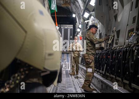 Senior Airman Frankie Arceo, 3rd Airlift Squadron loadmaster, prepares cargo chains before downloading a CH-47F Chinook helicopter from a C-17 Globemaster III assigned to Dover Air Force Base, Delaware, during a foreign military sales mission at Torrejón Air Base, Spain, Jan. 16, 2023. The United States and Spain are close allies and have excellent relations based on shared democratic values, including the promotion of democracy and human rights. Stock Photo