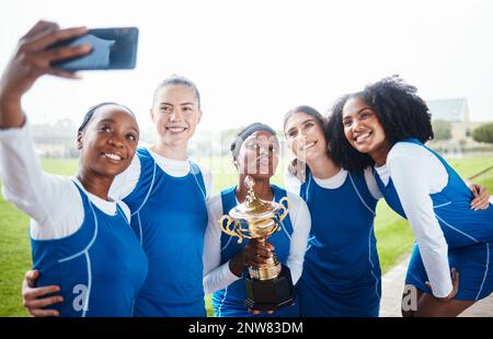 Black woman, friends and celebration in selfie, winning trophy or sports team on grass field outdoors. Happy sporty women smiling for photo or Stock Photo