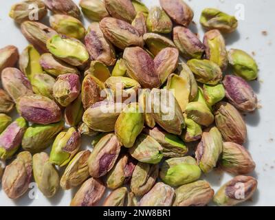 peeled pistachios isolated on white background Stock Photo