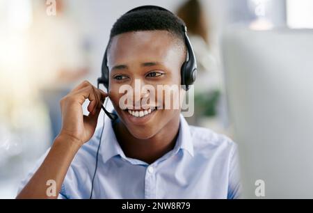 Our customers are at the heart of our organisation. Shot of a male agent working in a call centre. Stock Photo