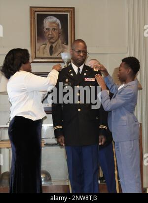 Illinois Army National Guard Chaplain (Lt. Col.) Vince Lambert's wife of 28 years, Latonia, and son, John, pin his new silver oak leaf rank unto his uniform. Chaplain Lambert, of Evergreen Park, Illinois, spent nearly two decades in finance, investment and bank management before deciding to join the Army as a member of the Chaplain Corps. “It was a surprising pivot,” LaTonia said. 'It was something he really wanted to do. It has been a journey that we are both excited to be on.' Lambert is the Deputy Command Chaplain of the Illinois Army National Guard helping provide Chaplain care to more tha Stock Photo