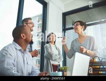 Working together to get the task done. Shot of businesspeople working together in the office. Stock Photo