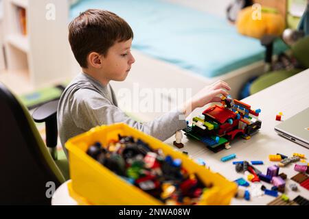 Ternopil, Ukraine - February, 2023: Boy Unboxing Hot Wheels City