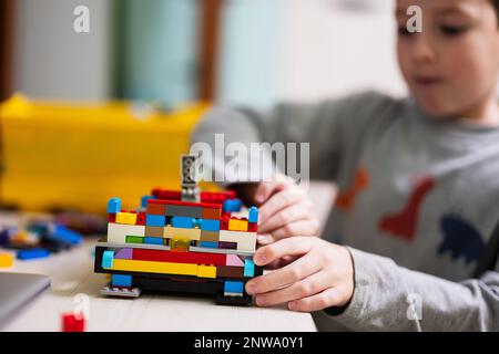 Ternopil, Ukraine - February, 2023: Boy Unboxing Hot Wheels City