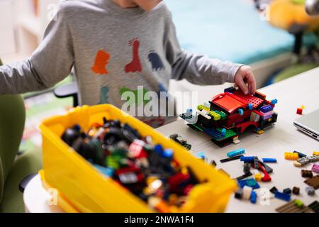 Ternopil, Ukraine - February, 2023: Boy Unboxing Hot Wheels City