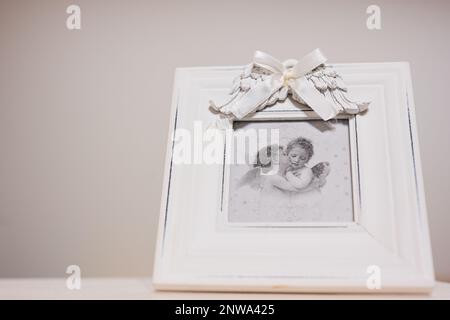 Ternopil, Ukraine - February, 2023: Baby angels with wings antique photo frame isolated. Stock Photo