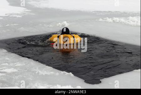 A firefighter wearing a cold-water immersion protective suit acts as a ...