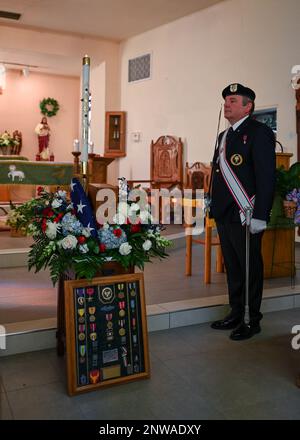 A member of the Knights of Columbus stands next to Chief Master Sgt. (Ret.) Paul Kerchums memorial during Kerchum’s funeral in Benson, Ariz., Jan. 25, 2023. Kerchum passed away Dec. 17, 2022, and was laid to rest with full military honors on, what would have been, his 103 birthday. Stock Photo