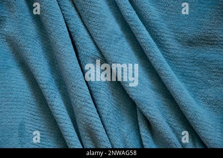 wrinkled soft light-colored fabric as a background, blue plaid for the background Stock Photo