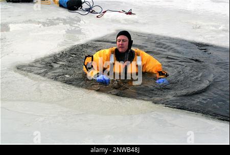 A firefighter wearing a cold-water immersion protective suit acts as a ...