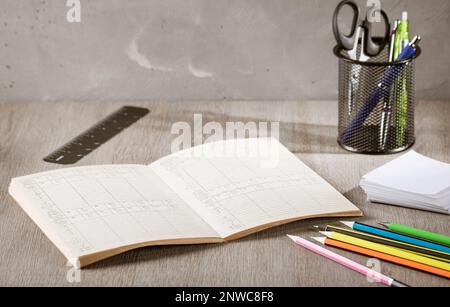 Office supplies - pencils, notepad, glasses and pencil case are on the office desk. Cozy working environment Stock Photo