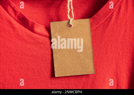 cardboard, packaging, casual, clothing, branding, shopping, brown paper price tag weighs on clothes on a rack on a hanger in the sales area, blank pri Stock Photo