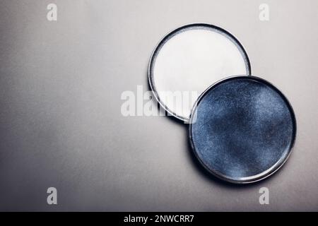 Top view of blue handmade ceramic plates. Close up of two vintage dishes on grey background. Space. Mockup. Stylish modern pottery. Stock Photo
