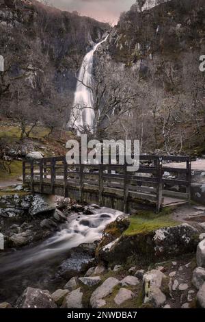 The wooden bridge at Aber Falls, a huge waterfall of about 37m near the village of Abergwyngregyn in North West Wales, UK Stock Photo