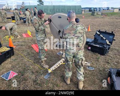 Members of the 263rd Combat Communications Squadron set up antenna and run cables for the Communications Flyaway Kit (CFK) at Marine Corps Air Station Cherry Point, N.C., Dec. 14, 2022. These efforts are in support of the 4th Fighter Wing Operations Center. Stock Photo