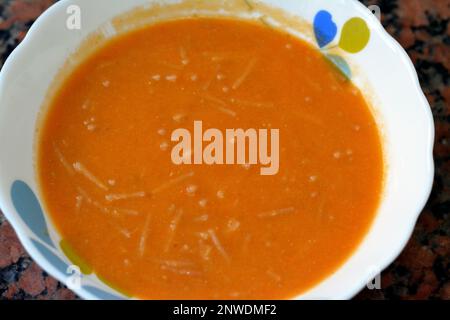 Lentil soup is a soup with lentils as its main ingredient; it may be vegetarian or include meat, using yellow red lentils with vermicelli, used in Eur Stock Photo