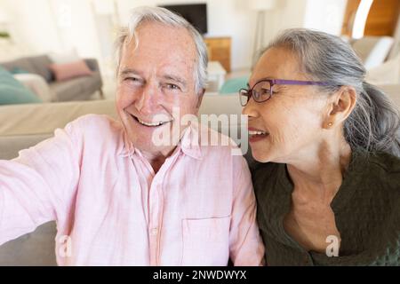 Happy senior diverse couple having video call Stock Photo