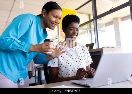 Diverse business people using laptop and having video call at office. Working at office, business, finances and corporation concept. Stock Photo