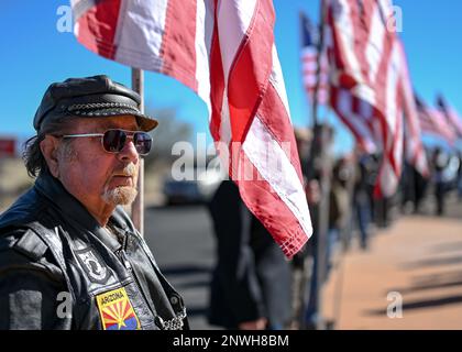 A man holds an American flag during Chief Master Sgt. (Ret.) Paul Kerchum’s Interment Ceremony at the Southern Arizona Memorial Veterans Cemetery, Sierra Vista, Ariz., Jan. 25, 2023. Kerchum passed away Dec. 17, 2022, and was laid to rest with full military honors on, what would have been, his 103 birthday. Stock Photo