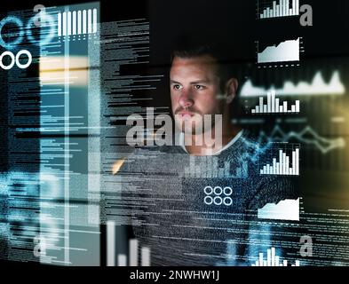Deciphering the metadata. Shot of a focussed computer programmer working at his computer late at night. Stock Photo