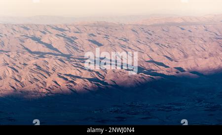 The valley of Palm Springs landscape in fall on a hazy, warm afternoon from aerial, above shot. Stock Photo