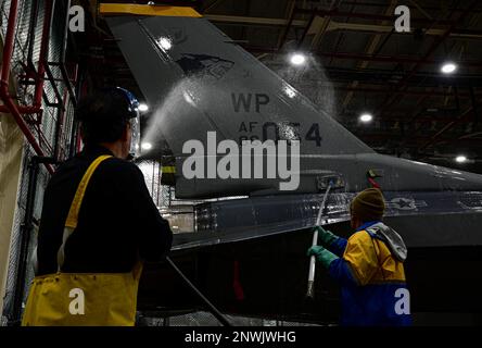 Kyong Taek Cho (left), 8th Maintenance Squadron corrosion control section aircraft painter and Kye Man Son (right), 8th Maintenance Squadron corrosion control section aircraft painter, wash an F-16 Fighting Falcon at Kunsan Air Base, Republic of Korea, Feb. 17, 2023. The 8th MXS performs preventative corrosion maintenance on aircraft from both the 80th and the 35th Fighter Squadrons at the Wolf Pack. Stock Photo