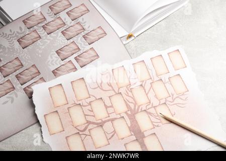 Blank family tree, notebook and pencil on wooden table, flat lay