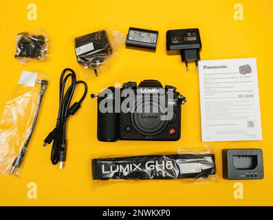 Paris, France - Nov 20, 2022: Directly above view of plastic film over Unboxing flat lay overhead lateral view of Panasonic Lumix DMC-GH6 Micro Four Thirds System digital still video camera with 5k 10 bit Video recording internal capability Stock Photo