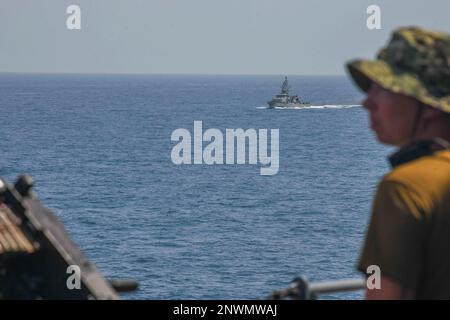 230203-N-TC338-1018  BAB AL-MANDEB (Feb. 3, 2023) The Cyclone-class coastal patrol ship USS Hurricane (PC 3), center, transits through the Bab al-Mandeb (BAM) strait with the Lewis B. Puller-class expeditionary sea base USS Hershel 'Woody' Williams (ESB 4), Feb. 3, 2023. Hershel 'Woody' Williams is on a scheduled deployment in the U.S. Naval Forces Africa area of operations, employed by U.S. Sixth Fleet to defend U.S., Allied and partner interests. Stock Photo