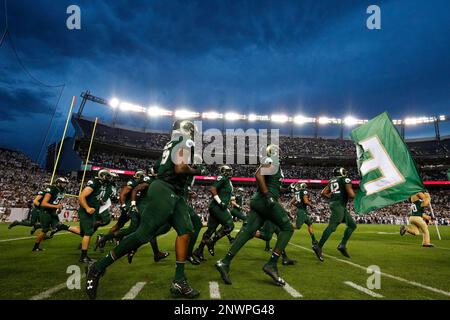 Denver Broncos players run on the field led by McTelvin Agim (95), Marquiss  Spencer (51), Justin Strnad (40), Jamar Johnson (41) with other following  to start an NFL football preseason game against