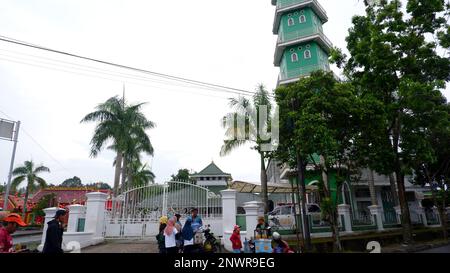 The Mosque Building With Green Towers And The Activities Of Residents In The City Of Muntok In The Morning Stock Photo