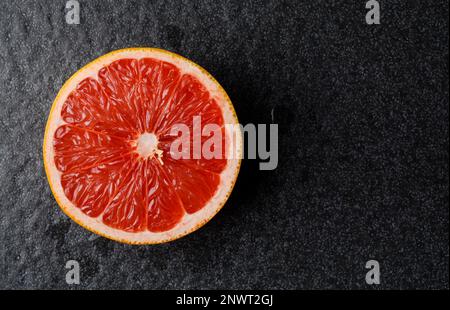 Closeup view of grapefruit on a red background Stock Photo