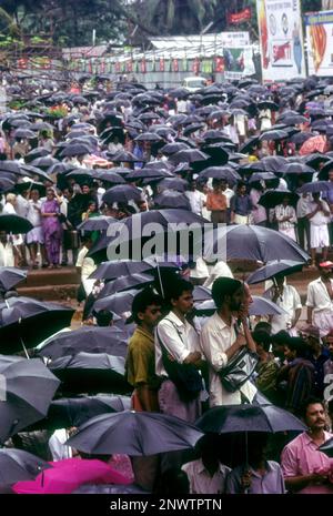 Crowd with umbrellas in raining during Pooram festival in Thrissur or Trichur, Kerala, India, Asia Stock Photo