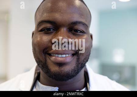 Portrait of happy african american male doctor with stethoscope in hospital. Health, hospital and care concept. Stock Photo