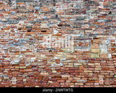 Old skewed traditional brick textured wall background in design loft style. Grunge reddish brown colored with copy space. Blank poster or wallpaper Stock Photo
